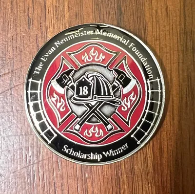 The Evan Neumeister Memorial Foundation Inc awards challenge coins to new firefighter recruits receiving Evans Memorial Scholarship covering tuition for Fire Academy