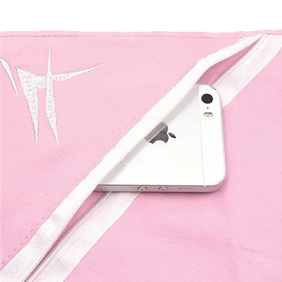 A white smartphone rests on a pink beach towel featuring a corner with a decorative embroidered white pattern, highlighting the towel's customizable option. (personalized beach towels)