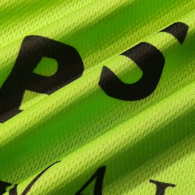 Close-up of a custom printed towel with black lettering on a vibrant green fabric, highlighting the detail and texture of the personalized product.