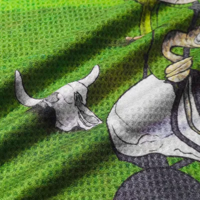 Close-up of a custom printed towel featuring a graphic design with a skull and vivid green background texture, likely to be personalized beach towels.